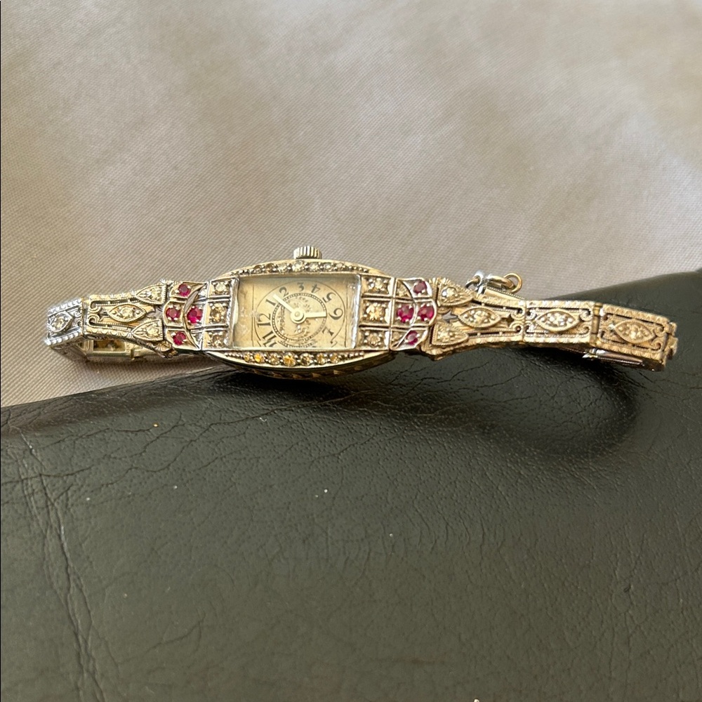 Elegant Gold and Silver Watch with Red Accents